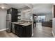 Open kitchen with island seamlessly flows into the living area with wood floors and skyline views at 800 N Pearl St # 1211, Denver, CO 80203