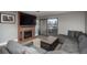 Comfortable living room features a brick fireplace, TV, grey sofa, and access to the outdoor balcony at 800 N Pearl St # 1211, Denver, CO 80203