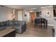 Open-concept living area flows into dining space and kitchen, with modern gray tones and wood flooring at 800 N Pearl St # 1211, Denver, CO 80203