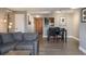 Open-concept living area flows into dining space and kitchen, with modern gray tones and wood flooring at 800 N Pearl St # 1211, Denver, CO 80203