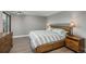 Comfortable primary bedroom with wood floors, bedside lamps, and a dresser with drawers for storage at 800 N Pearl St # 1211, Denver, CO 80203