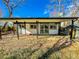 Backyard with covered patio, shed, and gravel area at 886 Kenton St, Aurora, CO 80010