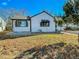 White house with black accents and a well-maintained lawn at 886 Kenton St, Aurora, CO 80010