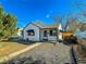 Charming white house with black accents and a gravel driveway at 886 Kenton St, Aurora, CO 80010