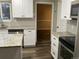Modern kitchen featuring granite countertops and white cabinetry at 886 Kenton St, Aurora, CO 80010
