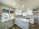 Bright kitchen with white cabinets, granite countertops, and an island at 886 Kenton St, Aurora, CO 80010