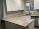 Renovated kitchen showcasing granite countertops and white cabinets at 886 Kenton St, Aurora, CO 80010