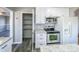 Renovated kitchen with white cabinets, granite countertops, and stainless steel appliances at 886 Kenton St, Aurora, CO 80010