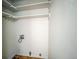 Laundry area with built-in shelving at 886 Kenton St, Aurora, CO 80010