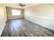 Living room featuring grey wood-look floors and ceiling fan at 886 Kenton St, Aurora, CO 80010