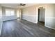 Spacious living room with grey wood-look floors and neutral walls at 886 Kenton St, Aurora, CO 80010