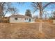 The home features a spacious backyard with a patio, new fence, and mature trees at 956 Racine St, Aurora, CO 80011
