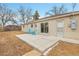 Backyard with brick home, patio and partial view of the yard at 956 Racine St, Aurora, CO 80011