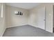 This carpeted bedroom features neutral walls and a window that lets in natural light at 956 Racine St, Aurora, CO 80011
