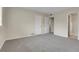 This carpeted bedroom features an ensuite bathroom, and neutral walls at 956 Racine St, Aurora, CO 80011