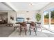 Bright dining room area with a modern table, chairs and view of the backyard at 956 Racine St, Aurora, CO 80011
