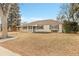Lovely single-story home featuring a front porch and mature trees at 956 Racine St, Aurora, CO 80011