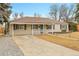 Charming single-story home with a well-manicured front yard and covered entryway at 956 Racine St, Aurora, CO 80011