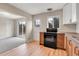 Open kitchen area features modern appliances and a sliding glass door to the backyard at 956 Racine St, Aurora, CO 80011