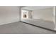 Open-concept living room with plush carpeting and view to adjoining kitchen space at 956 Racine St, Aurora, CO 80011