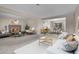 Open concept living room featuring a stone fireplace and large windows at 956 Racine St, Aurora, CO 80011