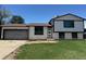 Charming two-story home with a well-maintained lawn and a convenient attached garage at 2513 S Crystal St, Aurora, CO 80014