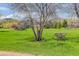 Expansive green lawn with an Arington Park sign, offering a serene and natural setting at 6155 Meadowbrook Dr, Morrison, CO 80465