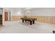 Finished basement showcasing a pool table, wood paneling, and neutral carpeting at 6155 Meadowbrook Dr, Morrison, CO 80465