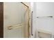 Bathroom featuring a glass shower door, handrails, and floral patterned wall tiles at 6155 Meadowbrook Dr, Morrison, CO 80465