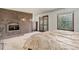 Spacious bedroom with brick fireplace, windows, and a door for plenty of light at 6155 Meadowbrook Dr, Morrison, CO 80465