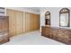 Carpeted bedroom with a light-colored wood dresser and multiple closets for storage at 6155 Meadowbrook Dr, Morrison, CO 80465
