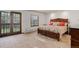 Bedroom with a large bed, wood trim windows, and a door leading to the backyard at 6155 Meadowbrook Dr, Morrison, CO 80465