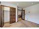 Spacious bedroom with plush carpeting, an oversized closet, and doorway to the hallway at 6155 Meadowbrook Dr, Morrison, CO 80465