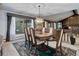 Elegant dining room showcasing a chandelier, and large windows with natural light at 6155 Meadowbrook Dr, Morrison, CO 80465