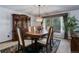 Formal dining room featuring a wooden dining set, chandelier, and a large window view at 6155 Meadowbrook Dr, Morrison, CO 80465