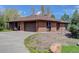 Charming brick home with a two-car garage and a curved driveway at 6155 Meadowbrook Dr, Morrison, CO 80465
