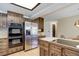 Kitchen featuring stainless steel appliances, wood cabinets, and counter cooktop on island at 6155 Meadowbrook Dr, Morrison, CO 80465