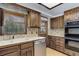 Functional kitchen with stainless steel dishwasher, double basin sink, and ample wood cabinetry at 6155 Meadowbrook Dr, Morrison, CO 80465