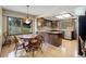 Well-lit kitchen with wood cabinetry, modern appliances, and a large center island at 6155 Meadowbrook Dr, Morrison, CO 80465