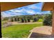 Scenic view from the property overlooking a green landscape and distant houses on a hill at 6155 Meadowbrook Dr, Morrison, CO 80465