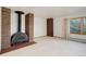 Living room with a unique fireplace, brick surround, carpeting, and a window with a view at 6155 Meadowbrook Dr, Morrison, CO 80465