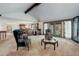 Open-concept living room with vaulted ceilings, neutral carpet, and views into the dining area at 6155 Meadowbrook Dr, Morrison, CO 80465