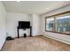 Living room with natural light, carpet flooring, and a large window with outdoor views at 6155 Meadowbrook Dr, Morrison, CO 80465