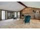 A spacious living room boasts a brick fireplace, wet bar, and large windows for ample natural light at 6155 Meadowbrook Dr, Morrison, CO 80465