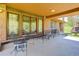 Spacious covered patio with classic outdoor furniture, ideal for entertaining or relaxing at 6155 Meadowbrook Dr, Morrison, CO 80465