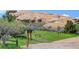 Picturesque view of the Willowbrook property with a unique rock formation and lush greenery at 6155 Meadowbrook Dr, Morrison, CO 80465