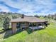 Expansive backyard features a covered patio, second-story balcony, and views of the scenic landscape at 6155 Meadowbrook Dr, Morrison, CO 80465