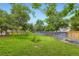 Landscaped backyard with trees and partial fencing create a peaceful and private outdoor space at 1497 S Oakland St, Aurora, CO 80012