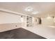The basement features recessed lighting, carpeting, storage shelves, and access to the stairs at 1497 S Oakland St, Aurora, CO 80012