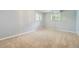Spacious finished basement with neutral carpet and natural light at 1497 S Oakland St, Aurora, CO 80012